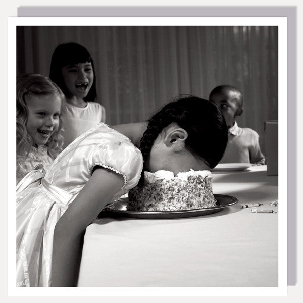greetings card, black and white photo, showing 4 children, one with her face in the cake